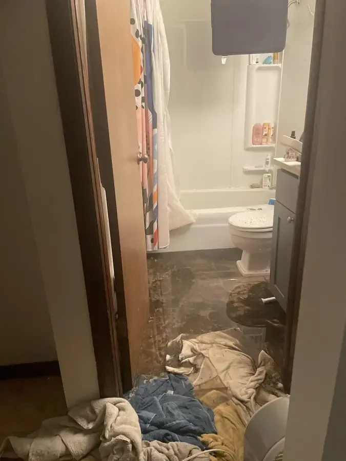 Soiled towels on a bathroom floor after a sewage backup