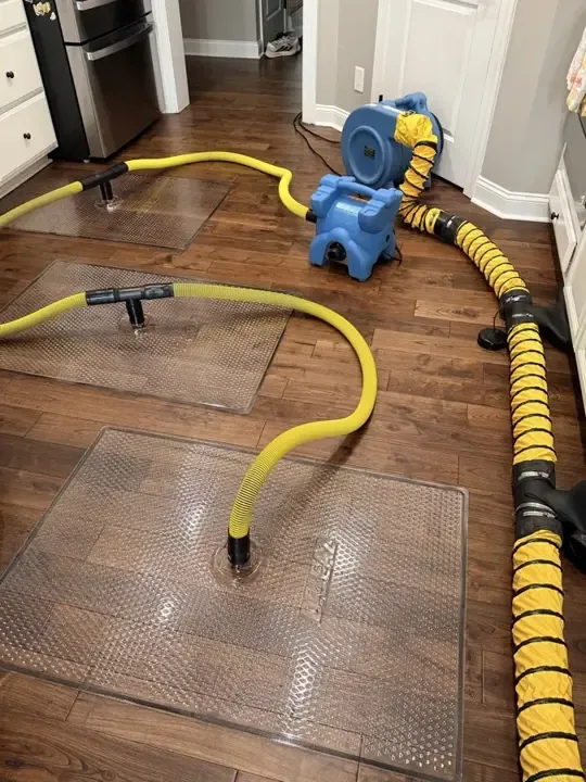 Drying mats and ducting pulling moisture out of a hardwood floor