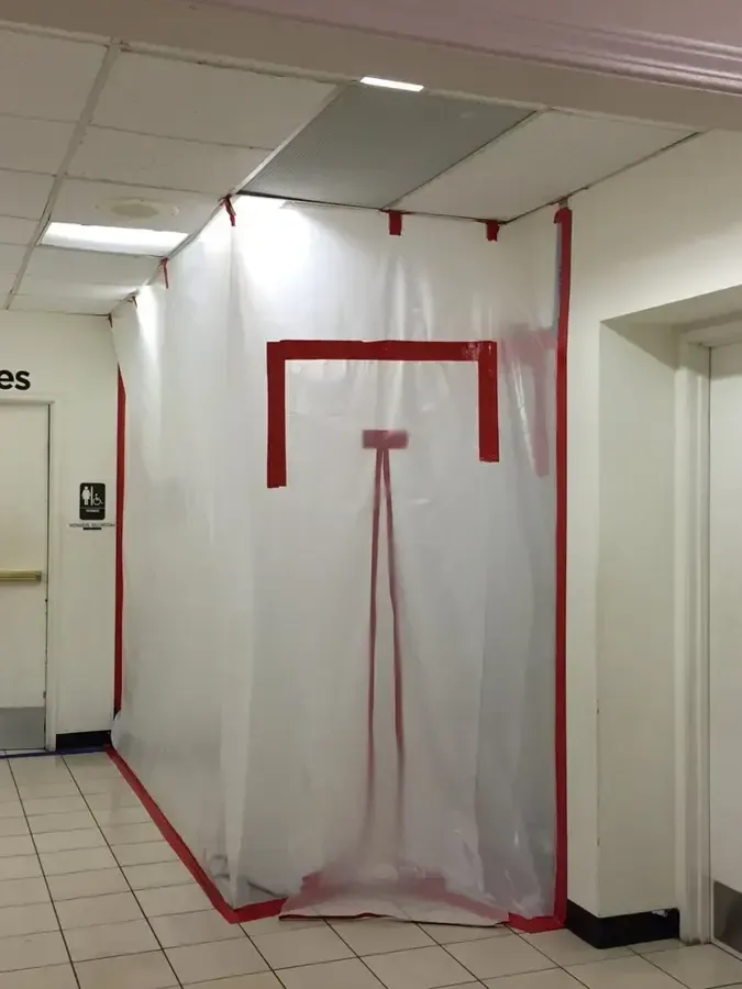 Office corridor sealed with plastic containment for drying